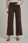 Brown wide leg stretch pants featuring decorative bow front pockets, high waist, and flared cropped hem.