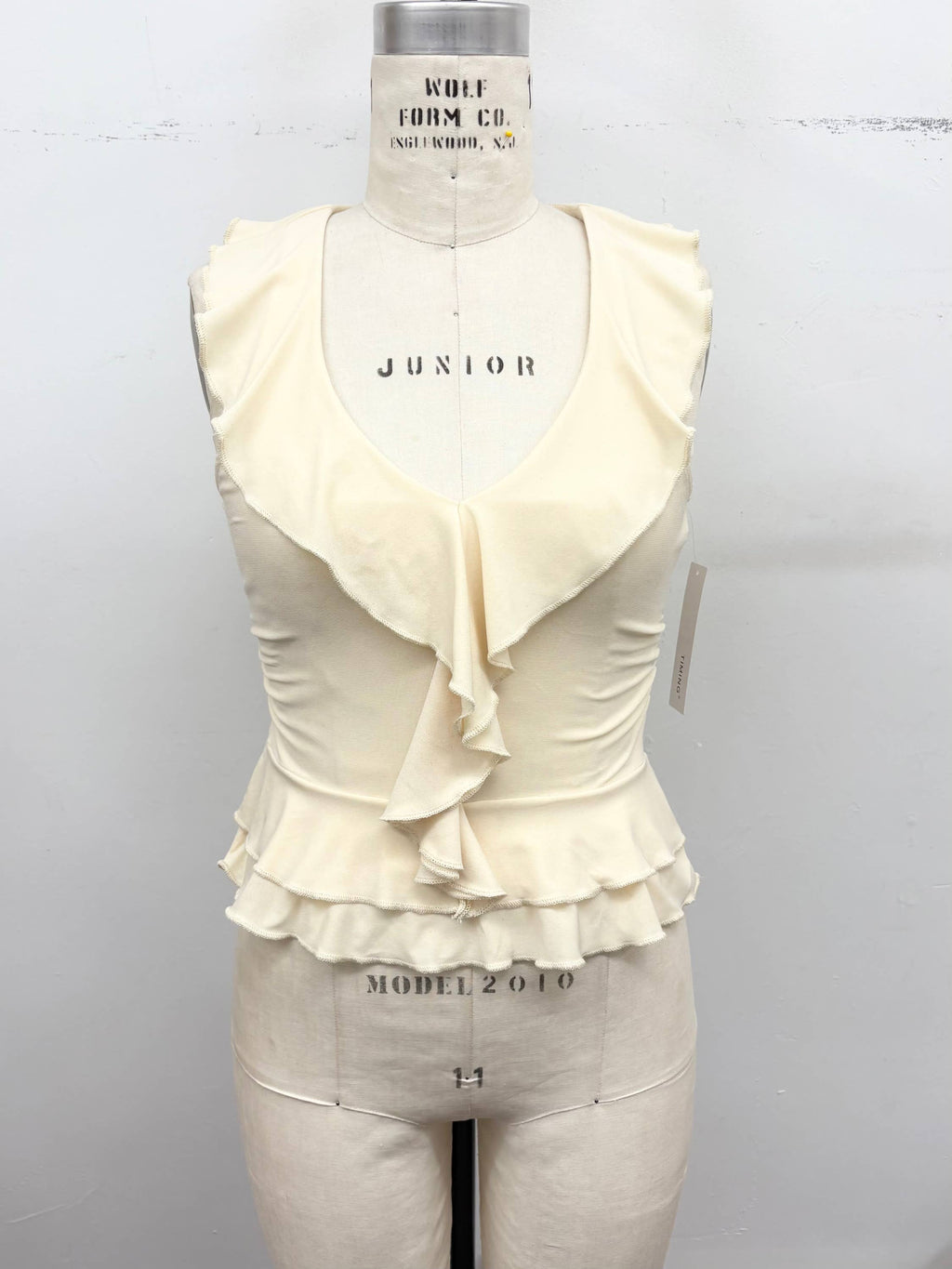 Ruffle Trim Sleeveless Peplum Top: Cream